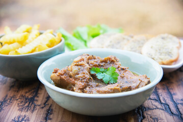 Pork stew serve with French fries and garlic bread