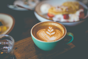 Latte hot coffee with foam milk art on a wooden table - 408016818