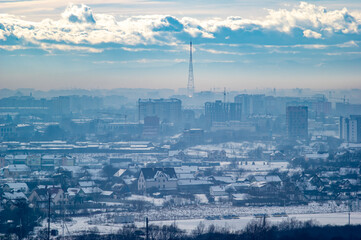 City from a height in smog on a winter day