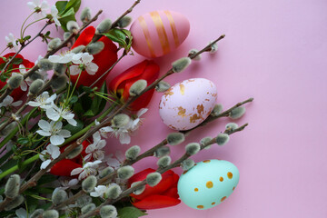 Easter greeting card. willow twigs, spring flowers and Easter eggs. space for congratulation text. flat lay