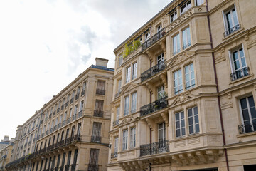 Fototapeta na wymiar Typical design of Parisian architecture hausmann facade of french building in block of apartments in bordeaux France