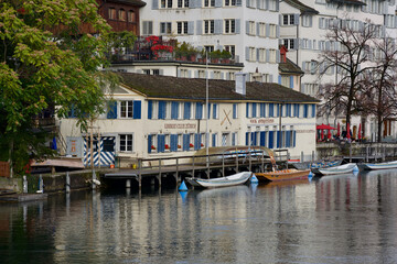 Old town of Zurich, Switzerland, with river Limmat and fixed boats.