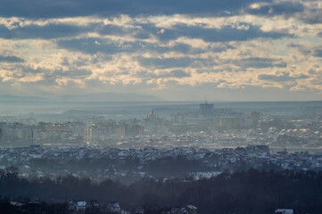 Fototapeta na wymiar City from a height in smog on a winter day