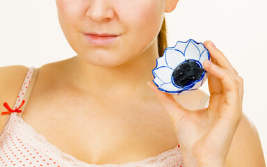Woman being apply black carbo mask to face