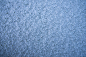 Fototapeta na wymiar Background, texture of fresh fallen snow. Snowflakes close-up. The winter time of year
