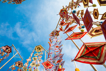 Colorful vary shape silk bunting decoration in outdoor summer festival party with blue sky...