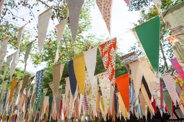 Colorful cloth bunting decoration in outdoor summer festival party. Vintage retro festival and celebration concept.