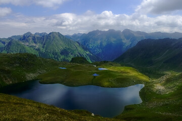 Fototapeta na wymiar wonderful blue mountain lakes in a mountain landscape while hiking