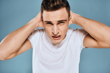 emotional displeased man cropped view white t-shirt blue background