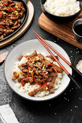 Homemade barbecue korean beef bulgogi with white rice. Black background