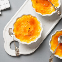 Fresh homemade creme brulee with burnt sugar on gray background. Top wiev