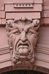 Detail of a keystone above an arch, showing a green man carving.