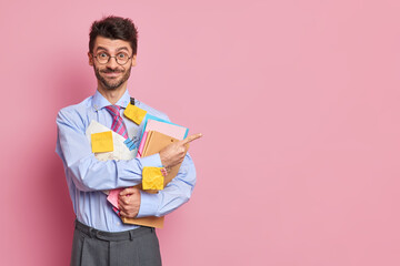 Happy positive unshaven man office worker demonstrates results of his research work stuck with...