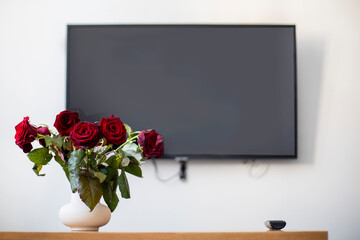 congratulatory bouquet of roses on the background of the screen, with an online conference, lockdown