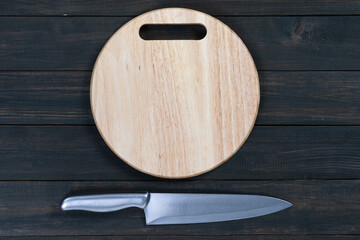 Close up kitchen knife and wooden round cutting board