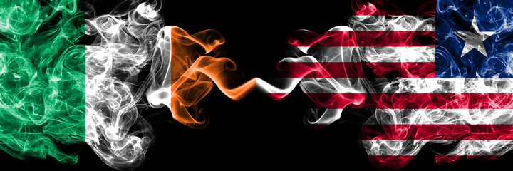 Republic of Ireland, Irish vs Liberia smoky mystic flags placed side by side. Thick colored silky abstract smoke flags.