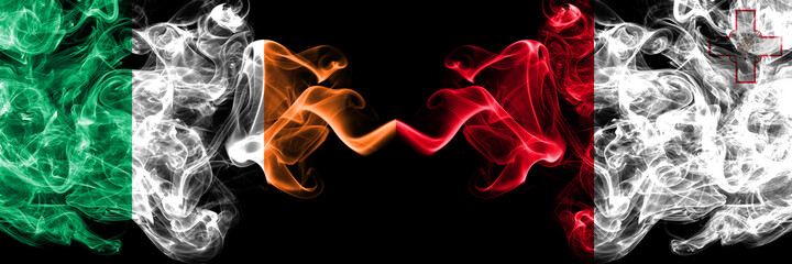 Republic of Ireland, Irish vs Malta, Maltese smoky mystic flags placed side by side. Thick colored silky abstract smoke flags.