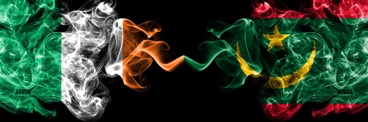 Republic of Ireland, Irish vs Mauritania smoky mystic flags placed side by side. Thick colored silky abstract smoke flags.