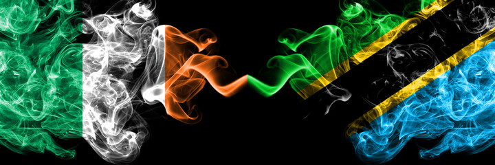 Republic of Ireland, Irish vs Tanzania smoky mystic flags placed side by side. Thick colored silky abstract smoke flags.