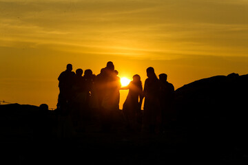 group of people at sunset