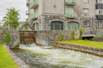 Middle River with water flowing into the lock at Fisherman’s Wharf on the east side of the Corrib...