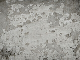 Abstract grunge texture. A very old wall with a cracked surface and some loose coating.