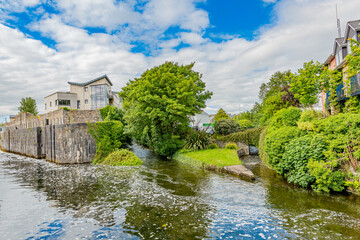 Water flowing calmly at the junction of the Eglinton Canal and adjacent canals surrounded by houses...