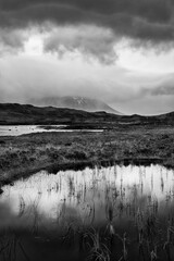 Epic dramatic  black and white landscape image of Loch Ba on Rannoch Moor in Scottish Highlands on a Winter morning
