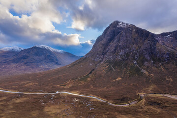 Flying drone epic landscape image of Buachaille Etive Mor and surrounding mountains and valleys in Scottish Highlands on a Winter day © veneratio