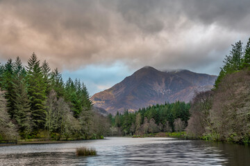 Stunning landscape image of Glencoe Lochan with Pap of Glencoe in the distance on a Winter's evening