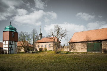 An old monastery courtyard with a bank and a small chapel