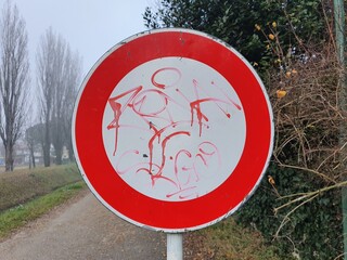 Red and white weathered no way sign with graffiti writing