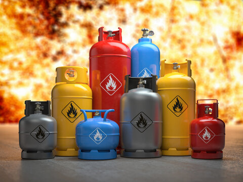 Gas tanks or bottles on explosive flame and fire background. Danger of using gas concept,