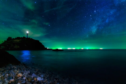 Long exposure photos. Lighthouse Star and the Milky Way at Lanta Island, Krabi Province, Thailand. © Thirawatana