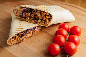 Turkish doner kebab with grilled meat. Juicy shawarma on wooden board