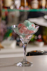 an unusual cup of cotton candy in a glass