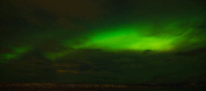 Northern lights Aurora Borealis in the nightsky on Senja Island in the Lofoten Islands of Norway.