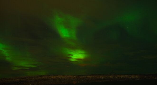 Northern lights Aurora Borealis in the nightsky on Senja Island in the Lofoten Islands of Norway.