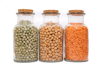 Dried Soup Mix, Split Lentils, Green Peas and Chickpeas. Dried and stored in glass bottles, Isolated against a white background. Preserved in jars. Three nutritious ingredients.