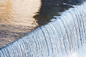 Water stream on a waterfall close up. Beautiful water background. Selective focus.