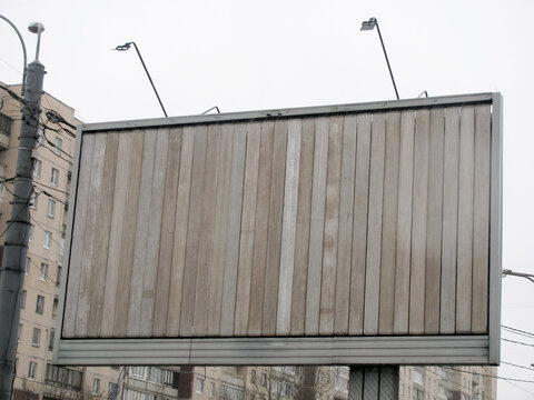 An empty wooden billboard in the form of a prismatron. Trivision billboard