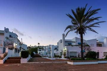typical white Andalusian buildings in La Duquesa at sunset