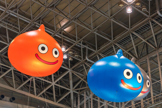 Chiba, Japan - December 22 2018:  Huge Inflatable Balloons Depicting Slime, The Mascot Of The Dragon Quest Role-playing Video Game Floating Under The Ceiling Of The Anime Convention Jump Festa 19.