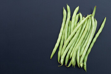 Green beans on dark background.