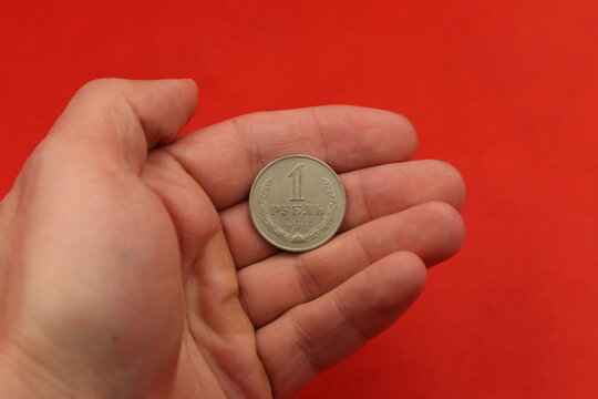 The Soviet Coin Ruble In Hand On Red Background