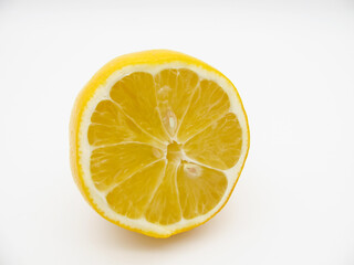 Fototapeta na wymiar Sliced yellow fresh lemon on a white background. Half of it.
