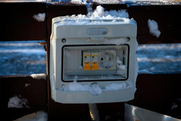 The electrical panel is damaged by snow.
