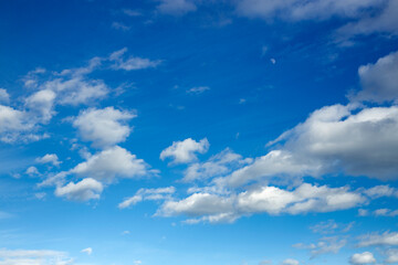 Naklejka na ściany i meble Deep blue sky with some clouds on a windy day