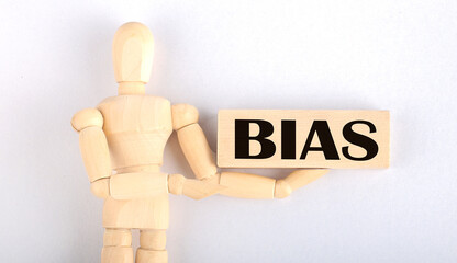 Wooden man shows with a hand to block with text BIAS
