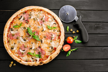 Tasty fresh pizza with ingredients on wooden background